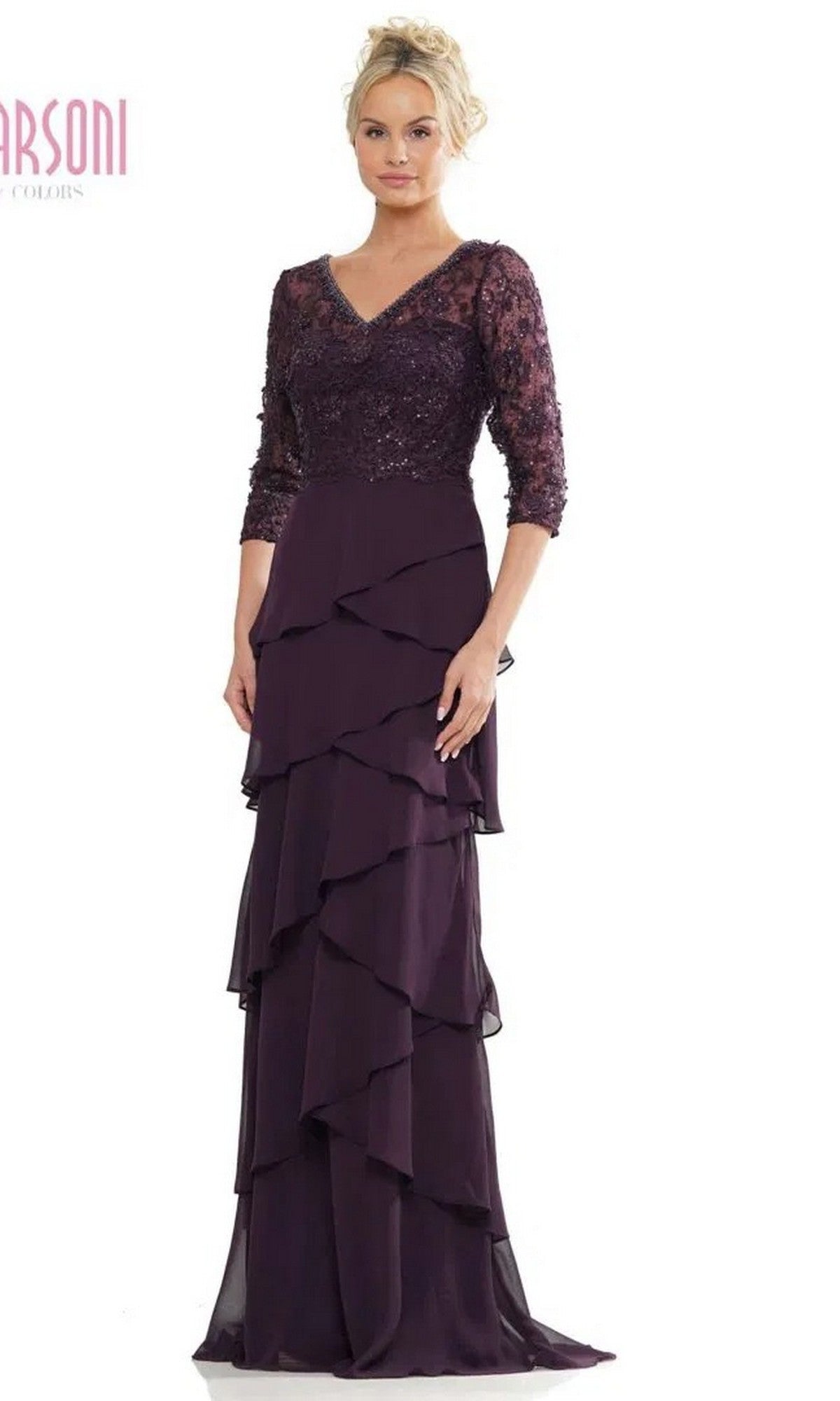 A woman models the Marsoni MV1244 long formal dress in eggplant, featuring a lace embroidered bodice, long sleeves, and a tiered chiffon column skirt, set against a plain white background.